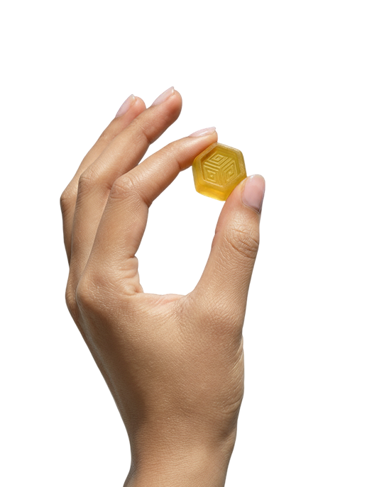 Hand holding a hexagonal hemp gummy